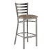 A Lancaster Table & Seating metal bar stool with taupe vinyl padded seat.