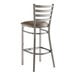 A Lancaster Table & Seating metal bar stool with taupe leather seat.