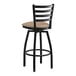 A black Lancaster Table & Seating ladder back bar stool with a taupe cushion.