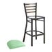 A Lancaster Table & Seating distressed copper ladder back bar stool with a seafoam vinyl padded seat.