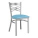 A Lancaster Table & Seating metal cross back chair with a blue vinyl cushion.