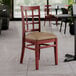 A Lancaster Table & Seating mahogany wood chair with a taupe vinyl seat.