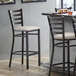 A Lancaster Table & Seating bar stool with light gray vinyl padded seat.