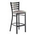 A metal ladder back bar stool with a distressed copper finish and a light gray vinyl padded seat.
