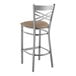 A Lancaster Table & Seating metal bar stool with a taupe vinyl padded seat.