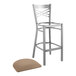 A Lancaster Table & Seating metal cross back bar stool with a taupe cushion.