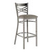 A Lancaster Table & Seating metal bar stool with a dark gray padded seat.