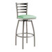 A Lancaster Table & Seating swivel restaurant bar stool with a green vinyl padded seat and metal legs.
