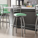 Lancaster Table & Seating clear coat finish ladder back swivel bar stools with seafoam vinyl padded seats.