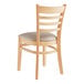 A Lancaster Table & Seating wooden restaurant chair with a light gray vinyl seat and ladder back.