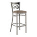 A Lancaster Table & Seating metal bar stool with a taupe vinyl cushion.