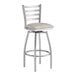 A Lancaster Table & Seating clear coat finish swivel bar stool with a light gray vinyl padded seat.