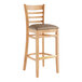 A Lancaster Table & Seating wooden bar stool with a taupe vinyl seat on a white background.