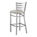 A Lancaster Table & Seating metal bar stool with a light gray vinyl padded seat.