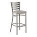 A Lancaster Table & Seating metal bar stool with a light gray cushion.