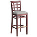 A Lancaster Table & Seating mahogany wood bar stool with a light gray cushion.