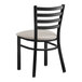 A black Lancaster Table & Seating metal chair with a light gray cushion.