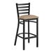 A Lancaster Table & Seating black metal ladder back bar stool with a taupe vinyl padded seat.