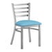 A Lancaster Table & Seating metal ladder back chair with a blue vinyl cushion.