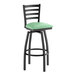A black metal ladder back swivel bar stool with a seafoam green vinyl padded seat.