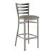A Lancaster Table & Seating metal ladder back bar stool with a dark gray cushion on the seat.