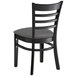 A Lancaster Table & Seating black wooden chair with dark gray cushion.