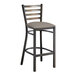 A Lancaster Table & Seating metal bar stool with a dark gray cushioned seat.