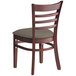 A Lancaster Table & Seating mahogany wood restaurant chair with a taupe vinyl cushion.