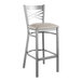 A Lancaster Table & Seating metal bar stool with a light gray padded seat.