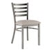 A Lancaster Table & Seating metal ladder back chair with a light gray cushion on the seat.