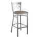 A Lancaster Table & Seating clear coat finish cross back bar stool with a dark gray cushioned seat.