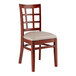 A Lancaster Table & Seating wooden chair with a light gray cushion and window back.