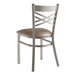A Lancaster Table & Seating metal cross back chair with a taupe vinyl padded seat.