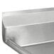 A close-up of the Advance Tabco three compartment stainless steel commercial sink with two drainboards.