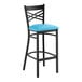 A black metal bar stool with a cross back design and a blue vinyl padded seat.