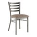 A Lancaster Table & Seating metal ladder back chair with taupe vinyl padded seat.