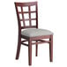 A Lancaster Table & Seating mahogany wood chair with a light gray cushion on the seat and back.