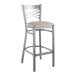 A Lancaster Table & Seating metal bar stool with a light gray cushion.