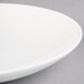 A close-up of a Homer Laughlin Alexa Ameriwhite bright white china salad plate with a rim.