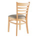 A Lancaster Table & Seating wooden chair with a dark gray cushion.