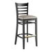 A black wood bar stool with a dark gray vinyl seat.