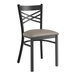 A Lancaster Table & Seating black metal chair with a dark gray padded seat.