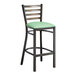 A Lancaster Table & Seating distressed copper metal bar stool with a seafoam vinyl padded seat.