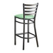 A Lancaster Table & Seating ladder back bar stool with a seafoam green cushion.