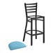 A Lancaster Table & Seating black ladder back bar stool with a blue vinyl padded seat.