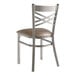 A Lancaster Table & Seating metal cross back chair with a taupe vinyl padded seat.