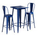 A Lancaster Table & Seating bar height outdoor table in blue with two chairs.