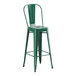 A Lancaster Table & Seating emerald green metal barstool with a backrest.