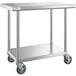 A Regency stainless steel work table with undershelf and casters.