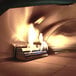 A close-up of a fire burning in a WPPO dual fueled outdoor pizza oven.